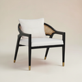 Trộm vía Kai armchair with black ash wood frame, rattan back, and removable crème cushion. Modern accent chair.